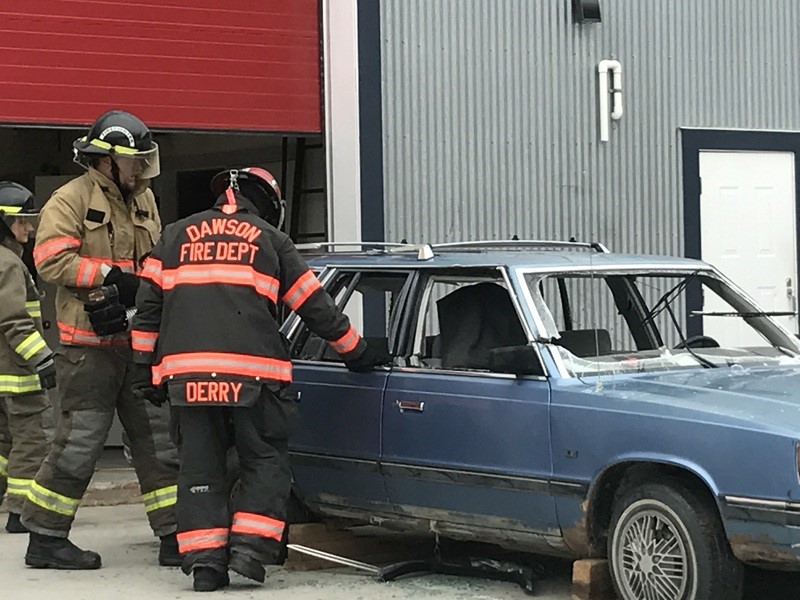Fire Fighters working on a car
